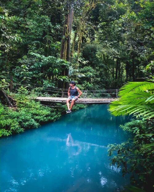 Bridge over blue water at Rio Celeste in Tenorio Volcano National Park