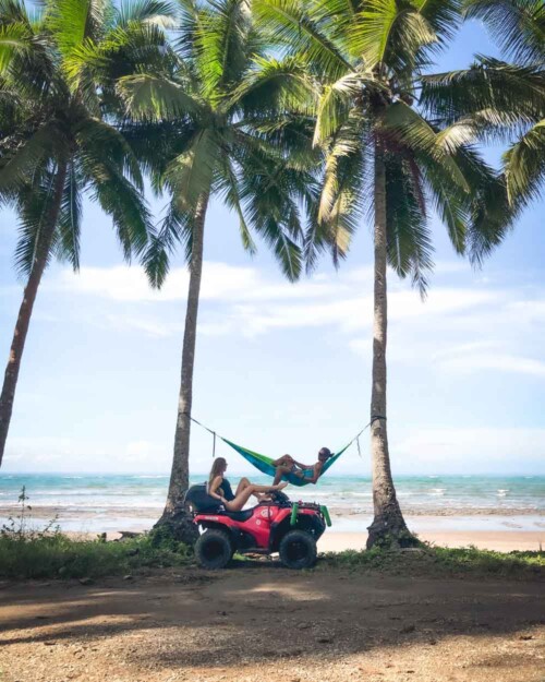 Piscoandbier between palm trees at Santa Teresa beach with hammock and ATV
